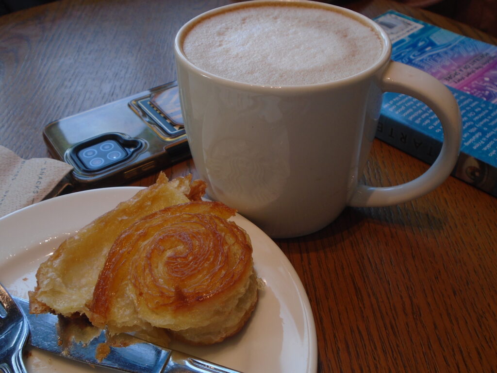 coffee, pastry, a book, and a phone - cold and brewed blog